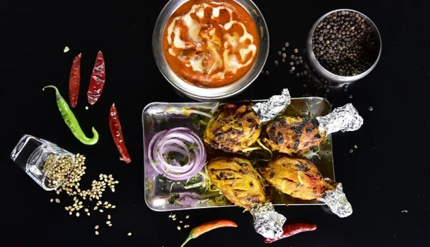 Tandoori meat and curry dishes with spices, representative of a Kashmiri Wazwan feast course