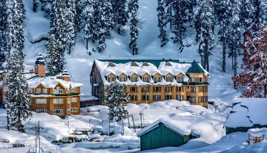 Wooden hotel buildings covered in deep snow among pine trees in Gulmarg Kashmir