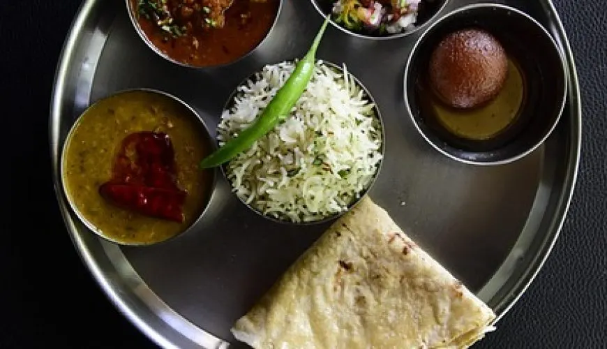 A traditional Indian thali plate with curry, rice and roti served at a restaurant